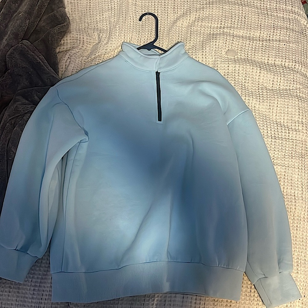 Selling a blue quarter zip jacket